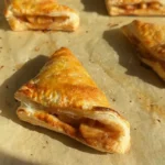 Freshly baked apple turnovers with a golden crust and apple filling