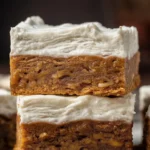 Frosted Gingerbread Brownies topped with creamy frosting, a festive holiday dessert.