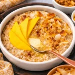 Creamy Coconut Oatmeal topped with coconut flakes, a delicious vegan breakfast dish.