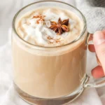 A delicious homemade chai tea latte with spices and creamy milk in a glass