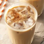 Starbucks Iced Pumpkin Cream Chai Latte topped with pumpkin cold foam and spices