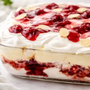 Heaven On Earth Cake layered with angel food cake, cherry pie filling, and creamy pudding.