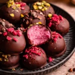 Delicious homemade Chocolate Raspberry Truffles coated in cocoa powder and raspberry.