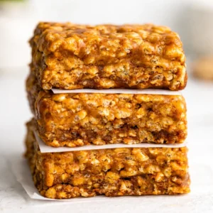 Homemade No-Bake Peanut Butter Protein Bars on a white plate, healthy snack option.
