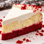 Delicious Knock You Naked Red Velvet Cheesecake topped with cream cheese frosting.