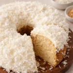 Deliciously moist Catch A Husband Cake topped with creamy coconut frosting.