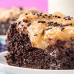 Deliciously moist German Chocolate Poke Cake topped with coconut pecan frosting.