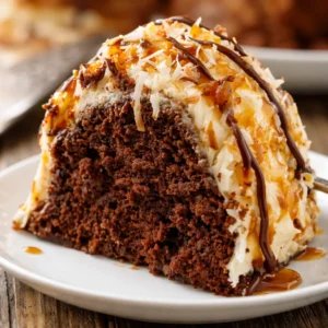Delicious Samoa Bundt Cake topped with caramel frosting, toasted coconut, and chocolate drizzle