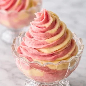 Frozen Strawberry Dole Whip Delight topped with fresh strawberries in a dessert bowl.