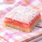 Delicious Hibiscus Lemon Bars with a bright pink hue and lemony filling.