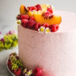 Delicious almond layer cake with peach filling, perfectly layered for a sweet treat.