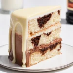 Delicious White Russian Poke Cake topped with whipped cream and Kahlua drizzle