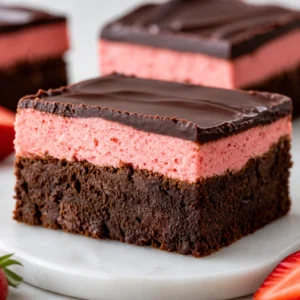 Delicious Strawberry Brownies topped with chocolate and fresh strawberries.