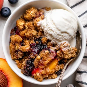 Delicious Blueberry Peach Crumble with juicy peaches and blueberries topped with a buttery oat crust.